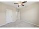 This is a lovely carpeted bedroom featuring a ceiling fan, neutral walls, and access to connecting rooms at 4145 Essex Pond Way, Cumming, GA 30040