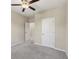 This is a lovely carpeted bedroom featuring a ceiling fan, neutral walls, and access to connecting rooms at 4145 Essex Pond Way, Cumming, GA 30040