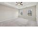 Inviting carpeted bedroom featuring natural light from two windows and a modern ceiling fan at 4145 Essex Pond Way, Cumming, GA 30040