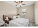 A bedroom with a large bed, white nightstands and neutral colored walls at 4145 Essex Pond Way, Cumming, GA 30040