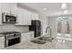 Modern kitchen with granite counters, stainless appliances, and pendant lighting above island at 4145 Essex Pond Way, Cumming, GA 30040