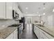 Well-equipped kitchen with a large island, stainless steel appliances, and gray backsplash at 4145 Essex Pond Way, Cumming, GA 30040