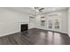 Bright living room with a fireplace, built-in shelving, and french doors to the outside at 4145 Essex Pond Way, Cumming, GA 30040