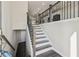 View of the entryway staircase with rod iron balusters and wood railing at 4145 Essex Pond Way, Cumming, GA 30040