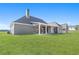 Expansive backyard with lush green lawn and covered patio, perfect for outdoor living at 101 Red Oak Ln, Carrollton, GA 30116
