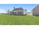 An exterior shot of the rear of a house with a covered porch overlooking a pristine lawn at 101 Red Oak Ln, Carrollton, GA 30116