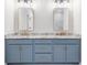 Modern bathroom vanity with double sinks, granite countertop, stylish mirrors, and gold accents at 101 Red Oak Ln, Carrollton, GA 30116