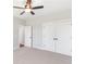 Bedroom with neutral walls, plush carpeting, and double door closet with black hardware at 101 Red Oak Ln, Carrollton, GA 30116