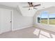 Bedroom featuring neutral walls, large windows providing ample natural light and an expansive view, plus a ceiling fan at 101 Red Oak Ln, Carrollton, GA 30116