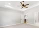 Bright bedroom featuring a ceiling fan, neutral walls, carpet, and an open doorway that leads to the kitchen at 101 Red Oak Ln, Carrollton, GA 30116