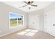Bedroom with neutral walls, carpet, and natural light from the window and features a closet and ceiling fan at 101 Red Oak Ln, Carrollton, GA 30116