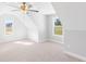 Bright bedroom with carpet, ceiling fan, and natural light from the windows with views of the land at 101 Red Oak Ln, Carrollton, GA 30116