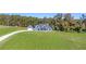 Home with an expansive green lawn is accessed by a long driveway from the main road at 101 Red Oak Ln, Carrollton, GA 30116