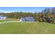Spacious home with a long driveway on a large lot, surrounded by lush greenery at 101 Red Oak Ln, Carrollton, GA 30116