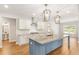 Modern kitchen with gray island and stainless steel appliances, and views to other rooms at 101 Red Oak Ln, Carrollton, GA 30116