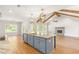 Open-concept kitchen and living room with vaulted ceilings, fireplace, granite island, and modern design at 101 Red Oak Ln, Carrollton, GA 30116
