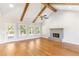 Bright living room featuring vaulted ceiling, wood beams, modern fireplace, and large windows at 101 Red Oak Ln, Carrollton, GA 30116