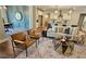 Open-concept living room featuring hardwood floors, stylish furniture, and a view into the kitchen and dining area at 101 Red Oak Ln, Carrollton, GA 30116