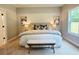 Serene main bedroom with a plush king bed, decorative pillows, and soft carpet flooring for ultimate comfort at 101 Red Oak Ln, Carrollton, GA 30116