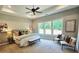 Spacious bedroom featuring a tray ceiling, large windows with natural light, and stylish decor for a relaxing retreat at 101 Red Oak Ln, Carrollton, GA 30116