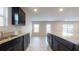 Modern kitchen features dark cabinets, granite counters, and an open layout at 620 Egrets Landing Lot #68 Lndg, Covington, GA 30014