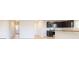 Modern kitchen with stainless steel appliances, granite countertops, and dark cabinets at 620 Egrets Landing Lot #68 Lndg, Covington, GA 30014