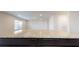 Close-up of the kitchen island, showing the granite countertop and dark wood cabinetry at 620 Egrets Landing Lot #68 Lndg, Covington, GA 30014
