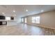 Bright open-concept living room with wood flooring connected to the kitchen at 620 Egrets Landing Lot #68 Lndg, Covington, GA 30014