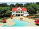 Stunning community pool area with red umbrellas and a charming clubhouse in a serene, wooded setting at 620 Egrets Landing Lot #68 Lndg, Covington, GA 30014