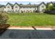 A townhouse backyard with a large grassy area and privacy fence at 2438 Brianna Dr, Hampton, GA 30228