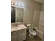 Bathroom featuring a vanity with a marble countertop, mirror with lights, tub and toilet at 2438 Brianna Dr, Hampton, GA 30228