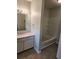 Bathroom featuring a white vanity with granite countertop and a tub/shower combo at 2438 Brianna Dr, Hampton, GA 30228