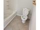 Bathroom featuring a white toilet next to a white tub/shower combo at 2438 Brianna Dr, Hampton, GA 30228