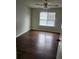 Bedroom featuring wood-look flooring, ceiling fan, and natural light from a large window at 2438 Brianna Dr, Hampton, GA 30228