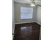A cozy bedroom featuring hardwood floors, a ceiling fan, and a window with blinds at 2438 Brianna Dr, Hampton, GA 30228