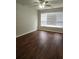 Bedroom featuring wood-look flooring, a ceiling fan, and natural light from a large window at 2438 Brianna Dr, Hampton, GA 30228