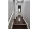 Hallway with wood-look floors leading to bathroom at 2438 Brianna Dr, Hampton, GA 30228