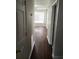 Hallway with laminate floors, freshly painted walls, and abundant natural light at 2438 Brianna Dr, Hampton, GA 30228