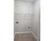 Compact laundry room with overhead shelving, offering efficient space for laundry needs at 2438 Brianna Dr, Hampton, GA 30228