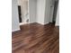 An open-concept living room with laminate floors, freshly painted walls, and abundant natural light at 2438 Brianna Dr, Hampton, GA 30228