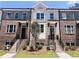 Three-story townhome with brick facade and front yard landscaping at 3157 Moor View Rd # 34, Duluth, GA 30096