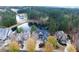 Aerial view showcasing an upscale home with a lush lawn near a golf course and lake at 6191 Talmadge Run, Acworth, GA 30101