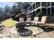 Outdoor lakeside fire pit with comfortable seating and landscaping at 6191 Talmadge Run, Acworth, GA 30101