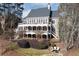 Beautiful backyard with a large deck, patio, fire pit, and manicured landscaping at 6191 Talmadge Run, Acworth, GA 30101