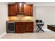 Well-appointed bar area featuring custom wood cabinetry and a convenient wine cooler at 6191 Talmadge Run, Acworth, GA 30101