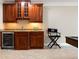 Elegant bar area showcasing custom cabinetry, granite countertops, wine cooler, and glass storage racks at 6191 Talmadge Run, Acworth, GA 30101