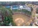 Aerial view of the neighborhood baseball field surrounded by trees at 6191 Talmadge Run, Acworth, GA 30101