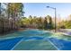 Well-maintained outdoor basketball court with a two-tone surface and secure fencing at 6191 Talmadge Run, Acworth, GA 30101