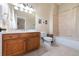 Bright bathroom features a wooden vanity, sink, and tile flooring at 6191 Talmadge Run, Acworth, GA 30101