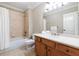 Bright bathroom boasts a vanity with a large mirror and a shower-tub combination at 6191 Talmadge Run, Acworth, GA 30101